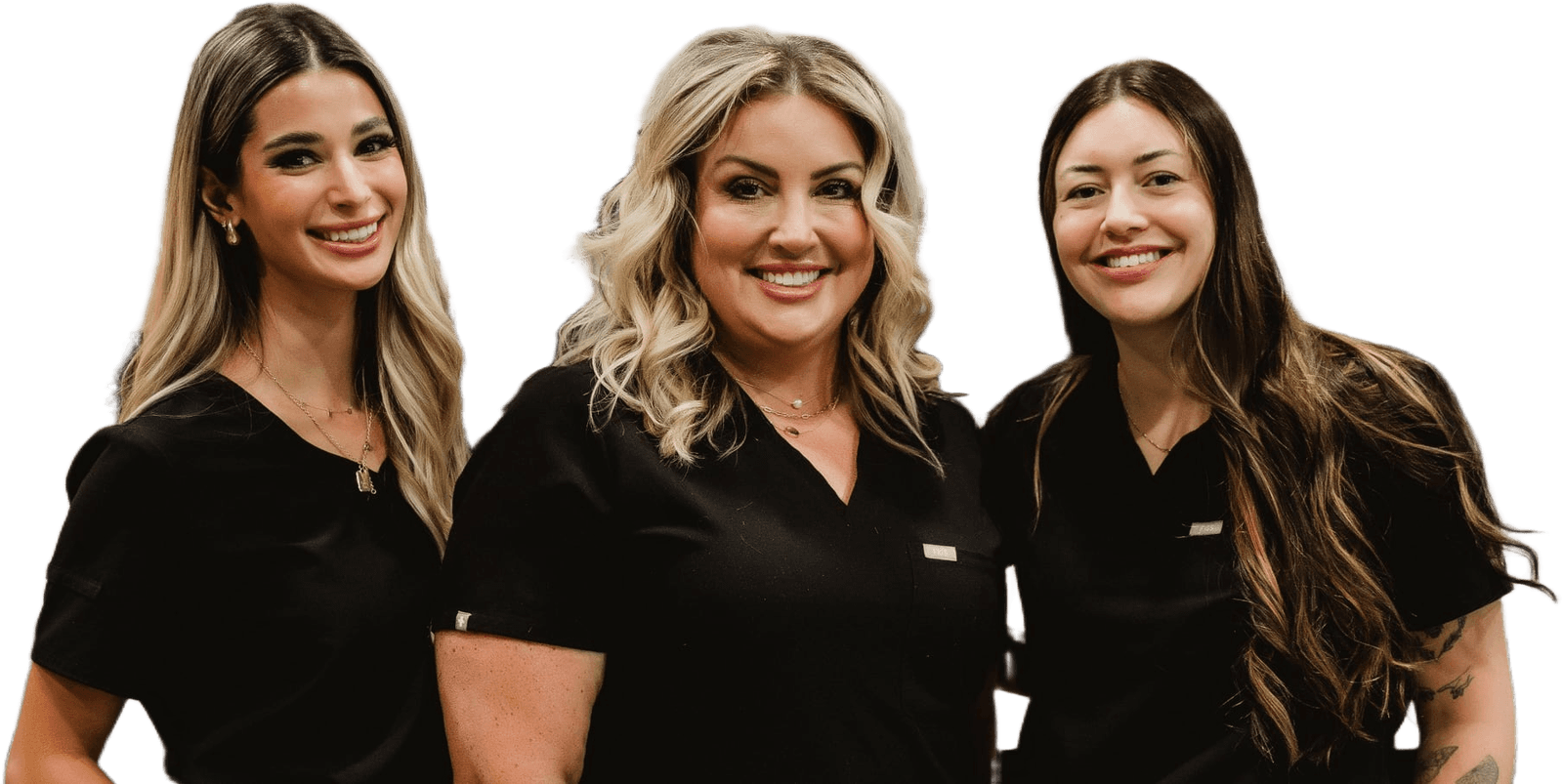 Grace, Steph, and Maggie in black scrubs, smiling