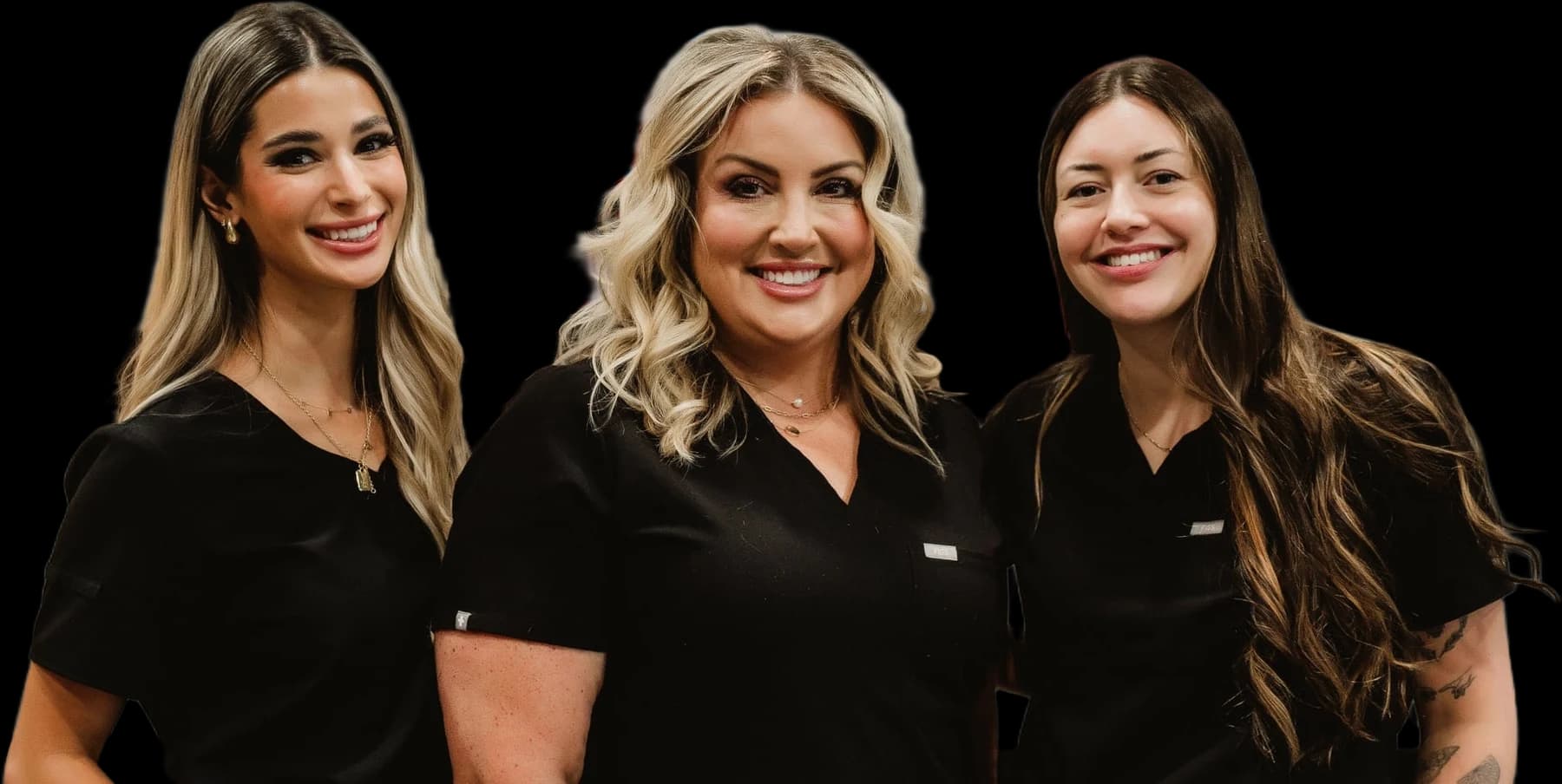 Grace, Steph, and Maggie in black scrubs, smiling