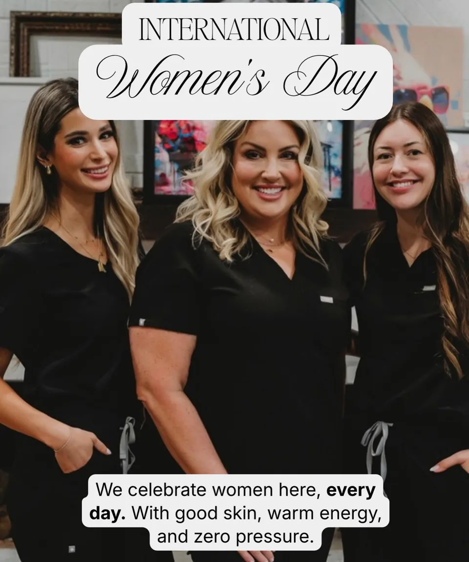 Three of the team in black scrubs for International Women's Day, colourful art on the mantel behind them (opens Instagram)